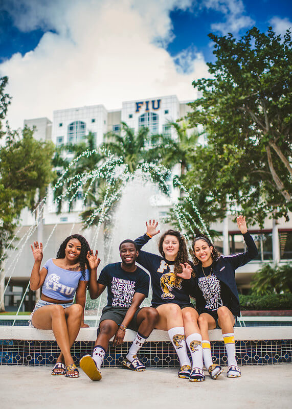 FIU students in front of the GC Foundation wearing FIU gear